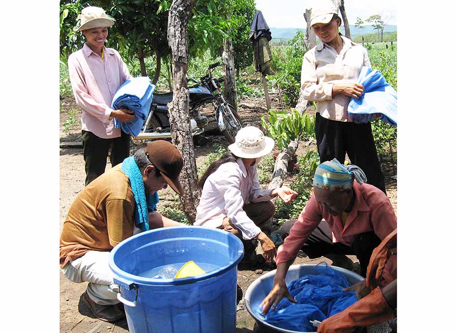  Cấp phát màn và tẩm màn bằng hóa chất cho người dân. Ảnh: Đ.P