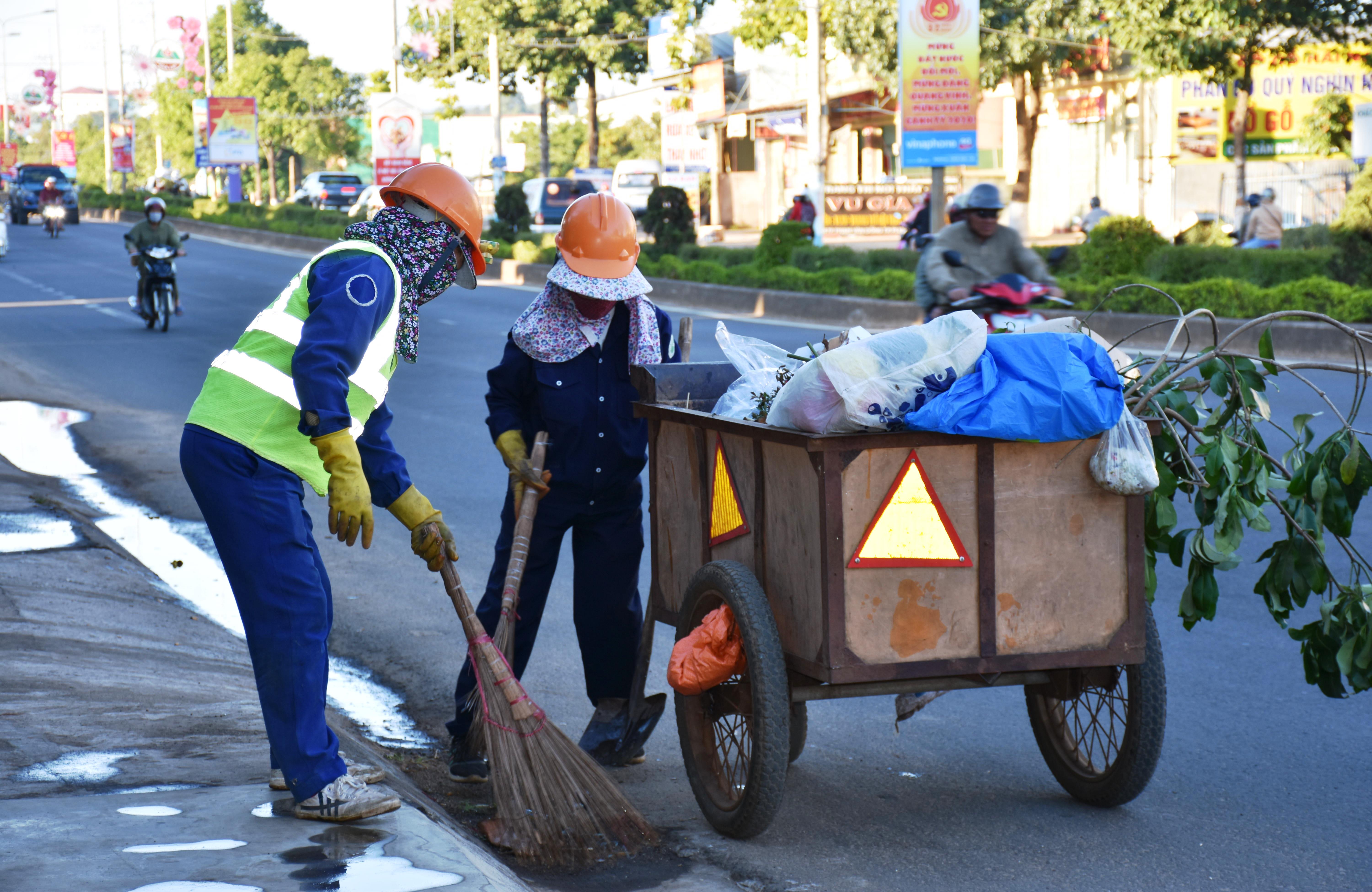 Công nhân vệ sinh môi trường đang tất bật làm sạch đường phố để tạo không gian sạch đẹp cho thành phố chào đón giao thừa. Ảnh: Trần Dung