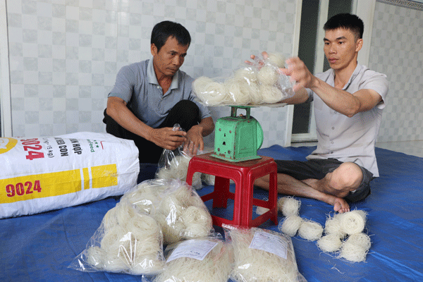 Anh Nguyễn Văn Diện (bìa phải) đóng gói sản phẩm giao cho khách hàng. Ảnh: N.M
