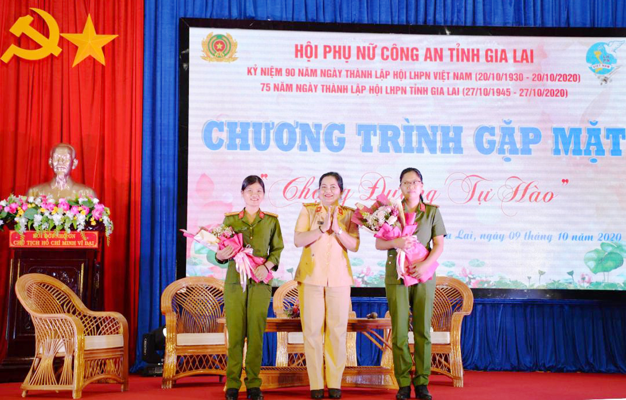 Thượng tá Lương Thị Thu Quỳnh-Chủ tịch Hội Phụ nữ Công an tỉnh tặng hoa cho  Trung tá Nguyễn Thị Thúy Nga (bìa trái) và Thiếu tá Nguyễn Ngọc Sáng tại buổi giao lưu. Ảnh: Thúy Trinh