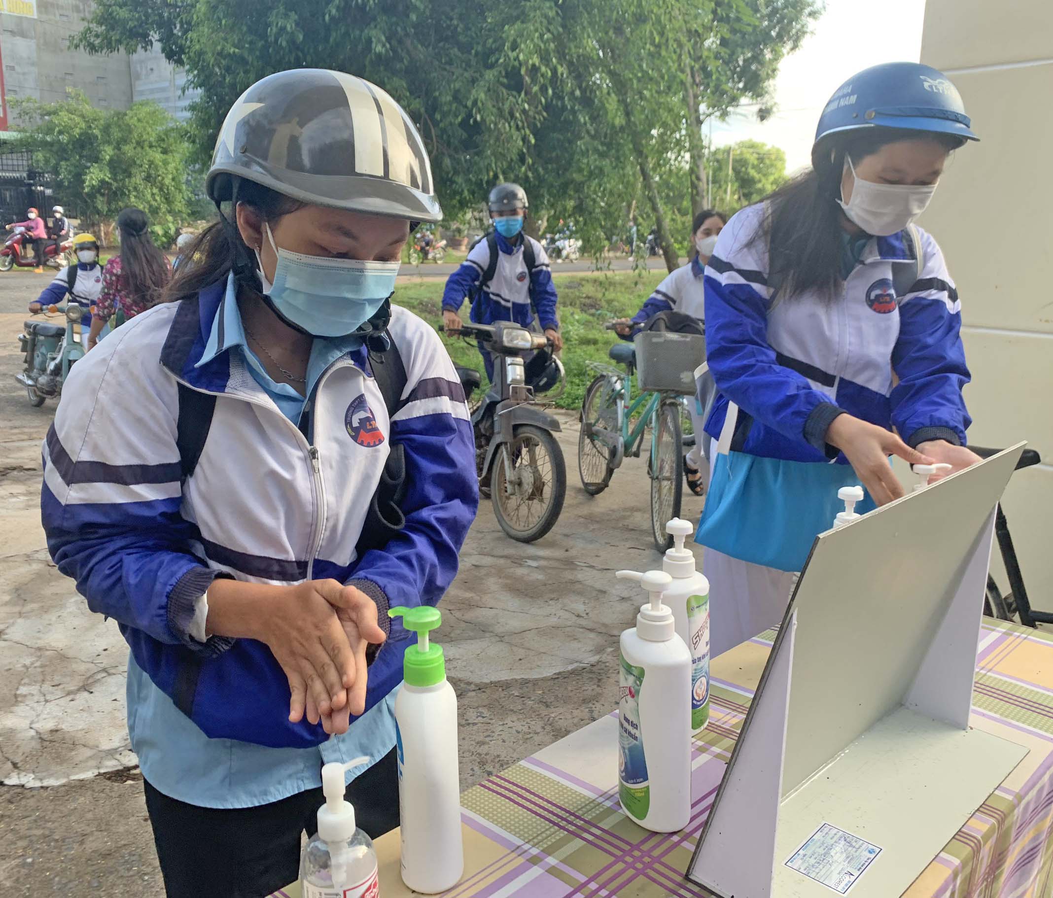 Học sinh Trường THPT Lý Thường Kiệt (thị xã Ayun Pa) rửa tay sát khuẩn trước khi vào trường. Ảnh: Vũ Chi