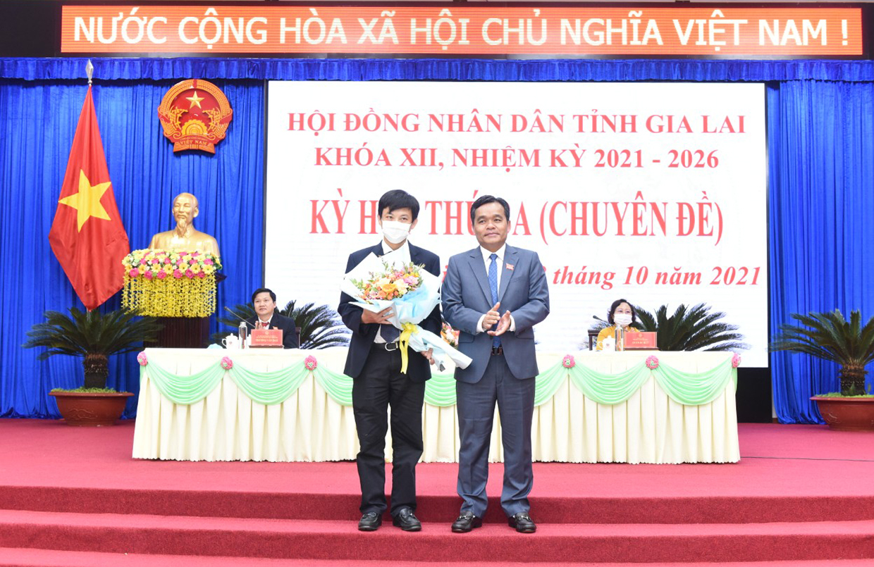 Bí thư Tỉnh ủy Hồ Văn Niên tặng hoa cho ông Đỗ Việt Hưng-Chủ tịch UBND TP. Pleiku, nguyên Giám đốc Sở Xây dựng vì đã hoàn thành nhiệm vụ Ủy viên UBND tỉnh. Ảnh: Đức Thụy