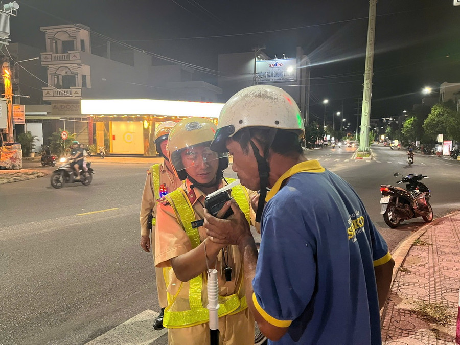 CSGT kiểm tra nồng độ cồn ngẫu nhiên, đồng thời nhắc nhở về quy định đã uống rượu bia, không lái xe đối với một trường hợp trên đường Huỳnh Tấn Phát (phường Quy Nhơn). Ảnh: K.A 1.jpg