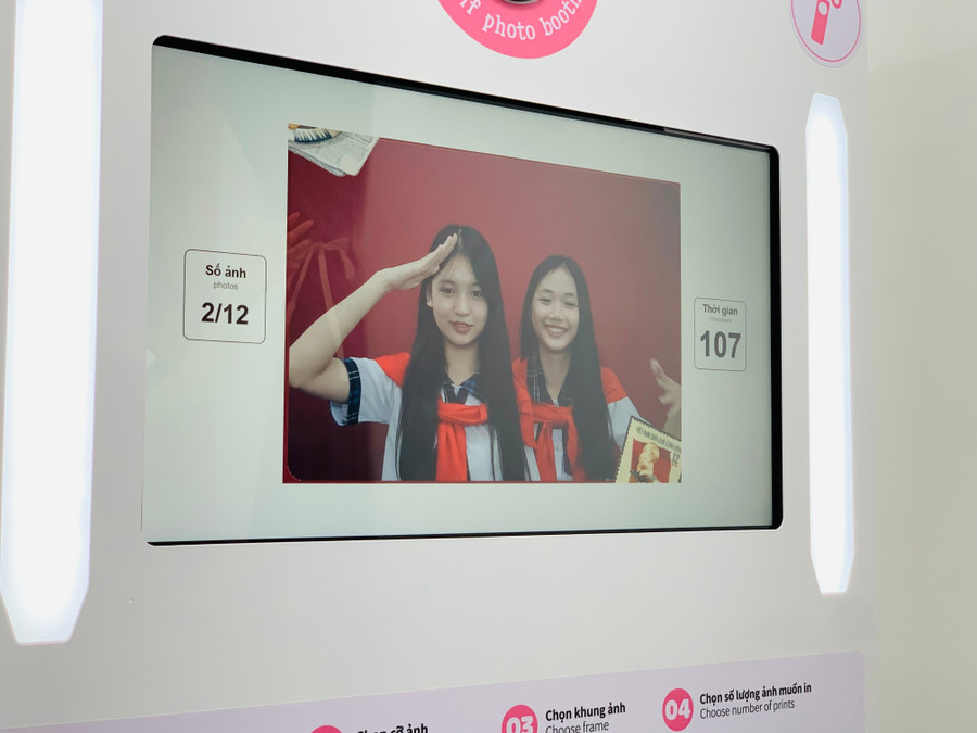 Bạn Võ Thị Hoàng Diệu (bên phải) lưu giữ không khí ngày lễ bằng chụp ảnh photobooth. Ảnh: Chu Hằng img-0808.jpg